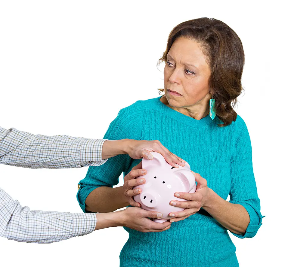 Closeup portrait elderly, shocked, suspicious senior business woman, grandmother, holding piggy bank, looking scared, trying to protect her savings from being stolen, isolated white background. Fraud