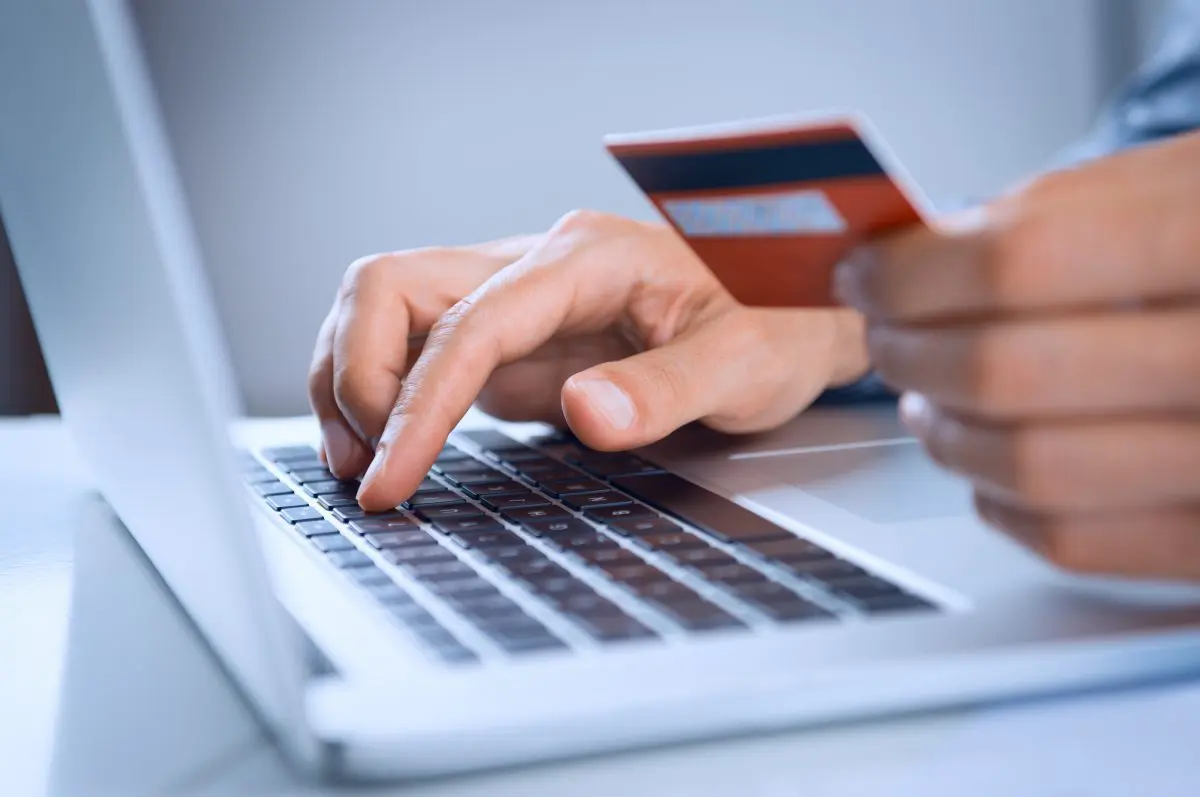 man using credit card to purchase something online