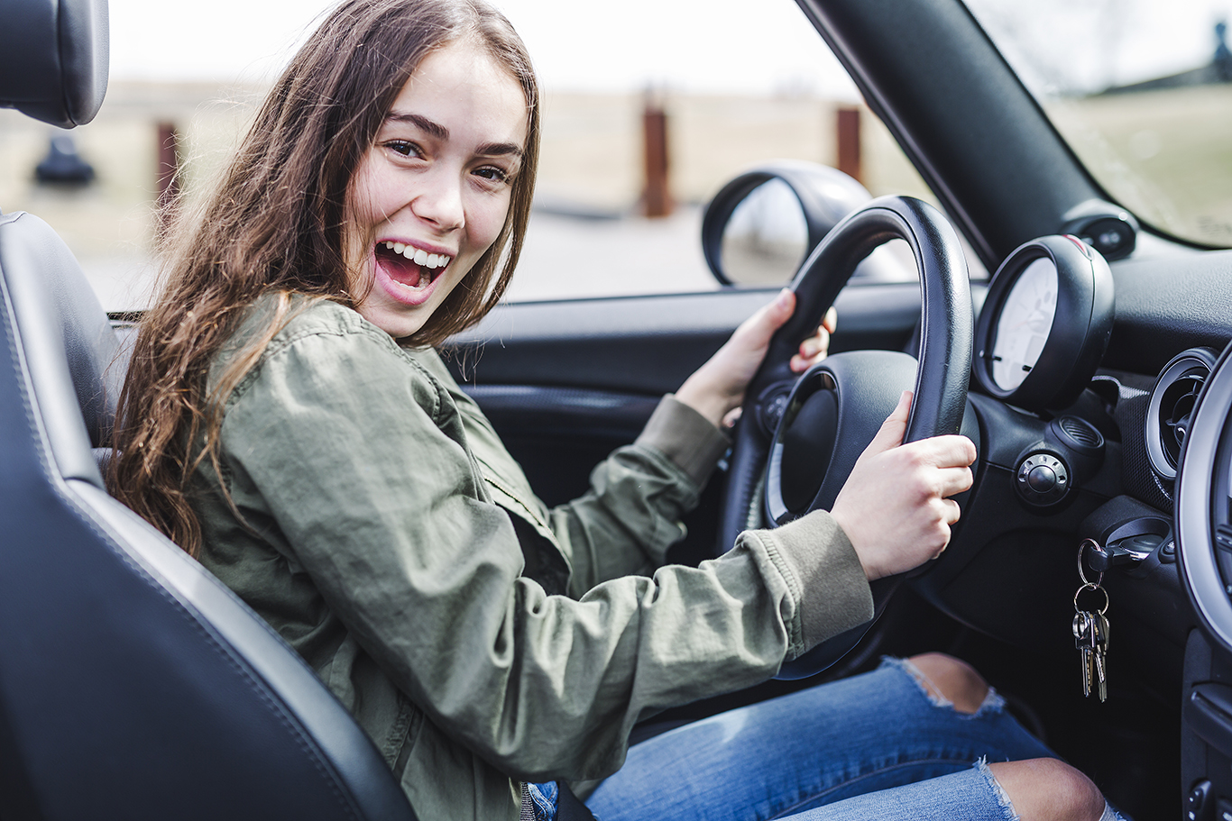 young brunette woman in new car;