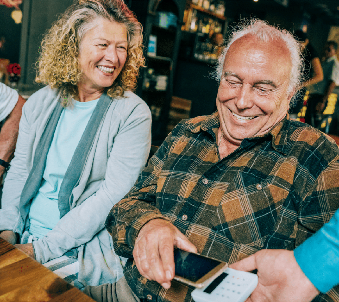senior couple paying with mobile wallet