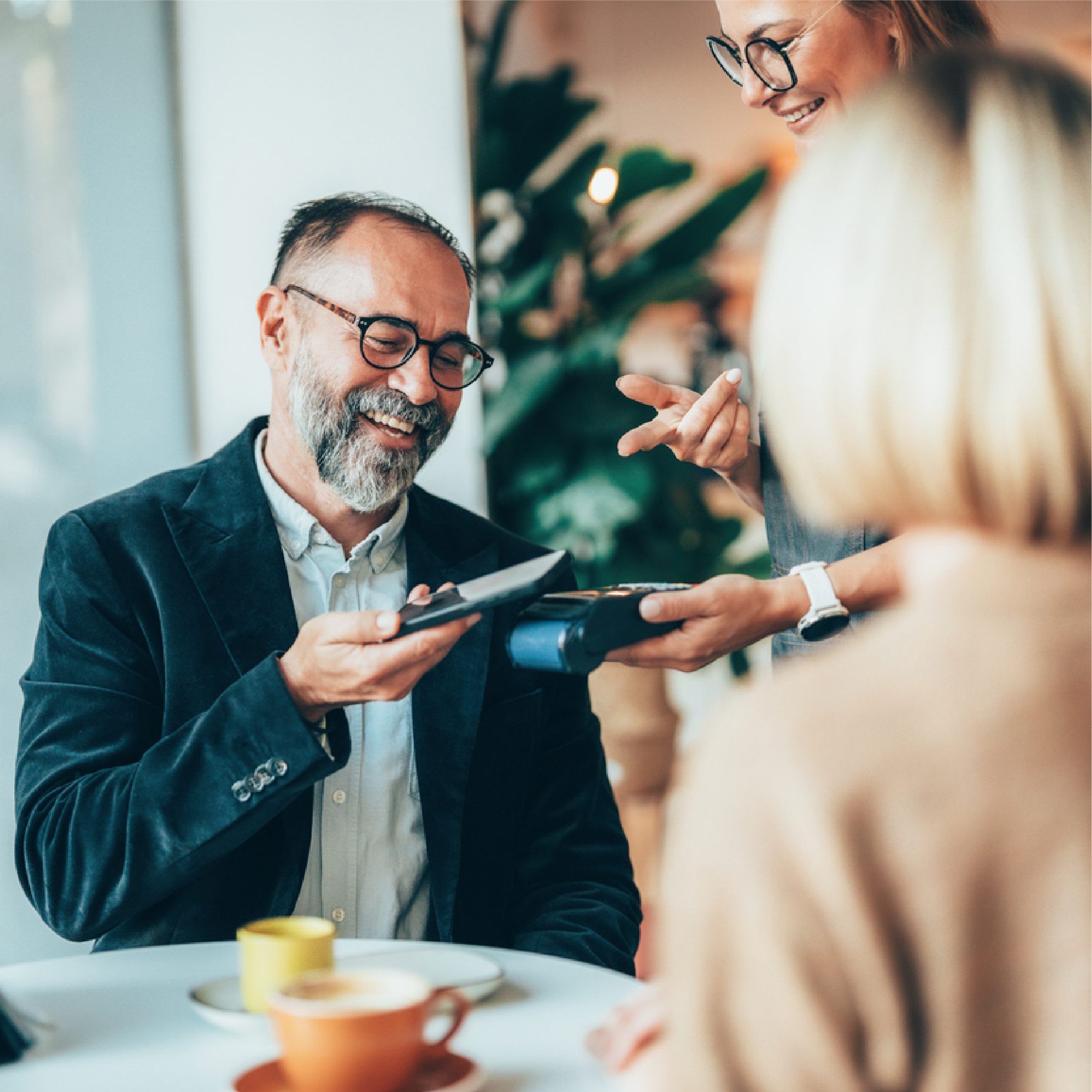 older man paying with mobile wallet
