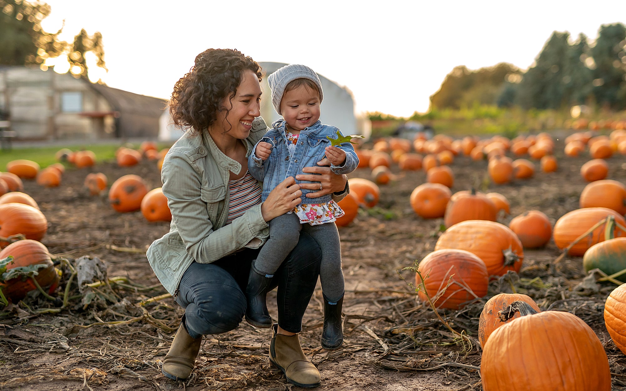 mother and child in pumpkin patch
